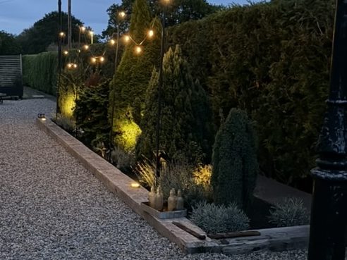 The old platform at dusk, lit by festoon lights